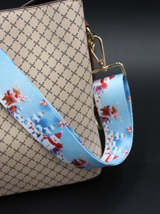 Close-up of wide Christmas theme bag strap with snowman and reindeer patterns