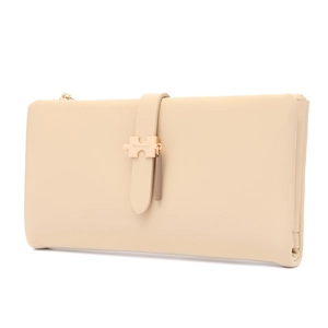 Detail of beige PU leather wallet featuring gold puzzle piece hardware and logo tassel