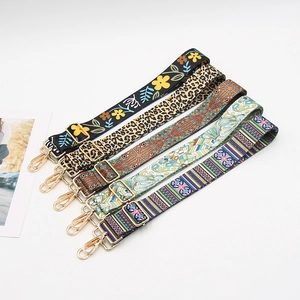 Collection of wide printed bag straps with diverse patterns and gold metal lobster hooks