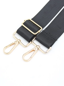Detailed view of wide black shoulder strap featuring gold-plated metal hooks and buckle