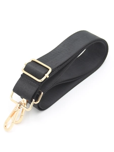 Detail of adjustable black fabric bag strap with high-gloss gold metal lobster clasps