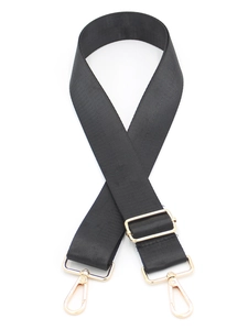 Close-up of black nylon patterned strap with adjustable gold-tone metal hardware