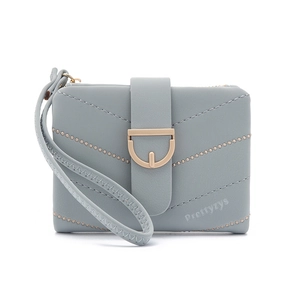Close-up of light blue quilted short wallet featuring D-ring buckle and wrist strap