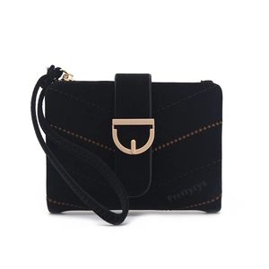 Close-up of black suede wallet featuring V-shaped stitching and golden D-ring buckle