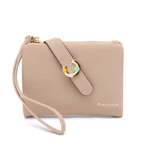 Detail of apricot pebbled leather wallet with metallic C-buckle and zipper wristlet strap