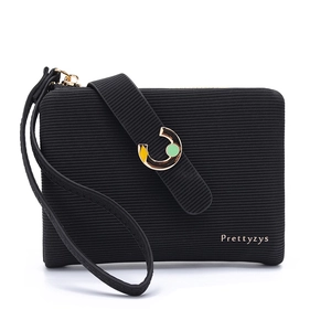 Close-up of black textured leather wallet with golden logo and enamel decorative buckle