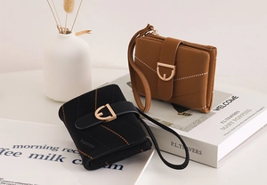 Quilted small wallets in black and brown with golden D-ring buckles and wrist straps