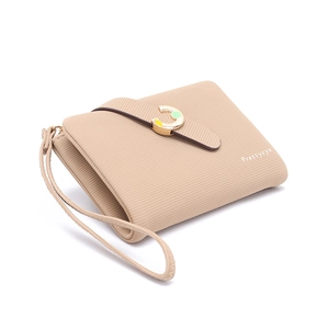 Close-up of light brown cross-pattern leather wallet with gold C-clasp and wristlet