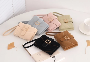 Detailed view of quilted PU leather wallets in multiple colors with gold D-ring hardware