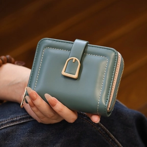 Close-up of minimalist teal and pink PU leather wallet with U-shaped buckle detail