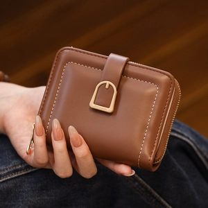 Detailed close-up of brown PU leather wallet showing contrast stitching and metal buckle