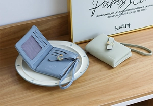 Short PU leather wallet with multiple card slots, zip pocket, and elegant metal C-buckle