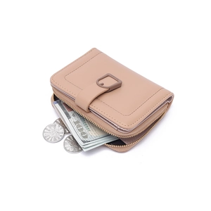 Detail of compact beige leather wallet showing spacious dual zippers and cash storage