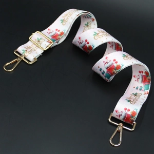 Christmas patterned bag strap with golden hardware and festive Merry Christmas print