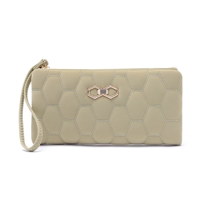 Detail of light green long wallet with honeycomb quilting and gold bow hardware