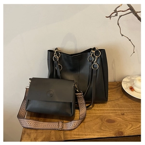 Black tote bag and crossbody set with gold rings and patterned woven strap