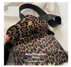 Gros plan du sac léopard montrant le fermoir magnétique en métal et la bandoulière