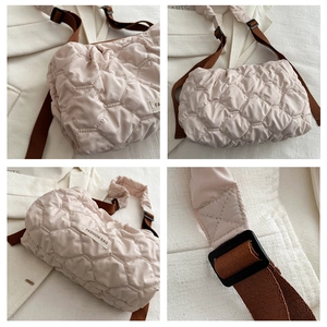 Detailed quilted texture and adjustable strap of the beige large capacity tote bag