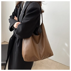 Detailed side view of large brown vintage leather hobo bag with textured finish
