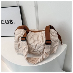 Quilted cream puffer shoulder bag with a wide caramel strap for commute fashion