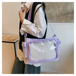 Detail of light purple messenger bag with clear window for displays and canvas texture