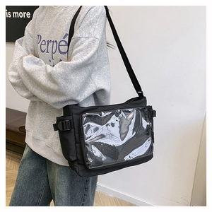 Side view of student carrying a black messenger bag with transparent PVC window detail