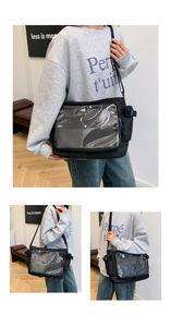 Detail of the black nylon ita bag featuring a large transparent PVC window and buckles