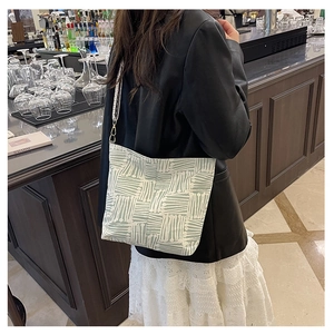 Detail of canvas tote bag with geometric patterns and adjustable wide shoulder strap