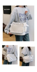 Detail view of white nylon tote bag showing clear display pocket and reinforced buckle