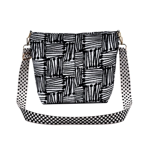 Large canvas tote bag with black and white abstract patterns and a wide patterned strap