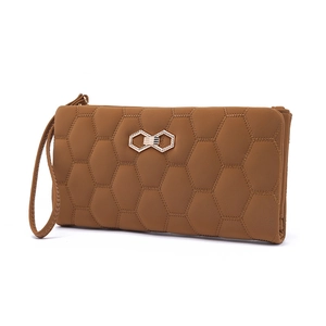 Detail view of camel PU leather long wallet featuring hexagonal quilted pattern and gold buckle