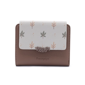 Close-up of contrast faux leather short wallet with leaf print and embossed logo
