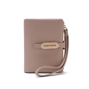 Detail of dusty pink PU leather wallet with litchi grain texture and wristlet strap