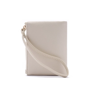 Detail of beige faux leather wallet with lychee texture and stitching on wrist strap