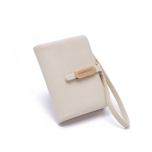 Close-up of beige PU leather wallet with litchi texture and golden metal buckle detail