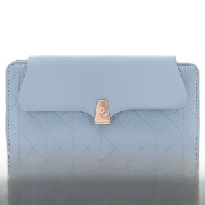 Detail of light blue PU leather wallet featuring quilted texture and golden rose clasp