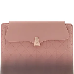 Detailed macro of pink PU leather wallet with diamond quilting and tulip metal clasp
