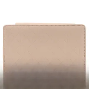 Detail of light pink long purse with elegant diamond quilted stitching and PU leather texture