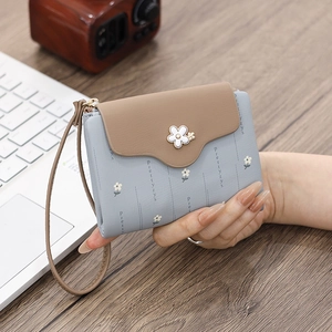 Detail of PU leather wallet with daisy floral print and 3D flower metal clasp closure