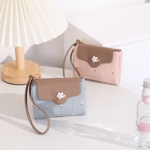 Close-up of PU leather short wallet with flower print and contrast brown flap detail