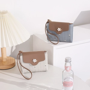 Detail view of floral PU leather wallets with flower clasp and zip closure
