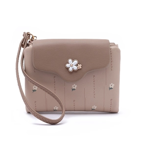 Detailed view of women's short wallet with lychee texture and floral metal clasp