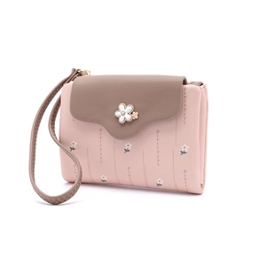 Close-up of the pastel pink and taupe PU leather finish with delicate floral buckle