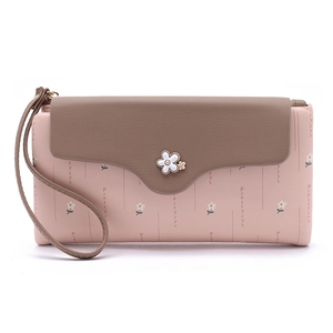 Detail of pink and brown women's long wallet with floral print and white flower clasp