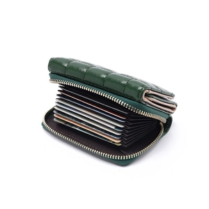 Quilted dark green tri-fold wallet for women with zipper closure and accordion card slots