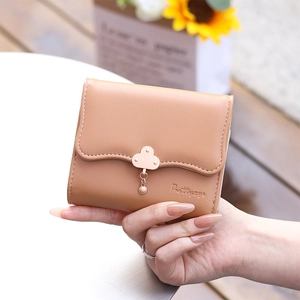 Close-up of khaki leather tri-fold wallet featuring wave edge and cloud metal clasp