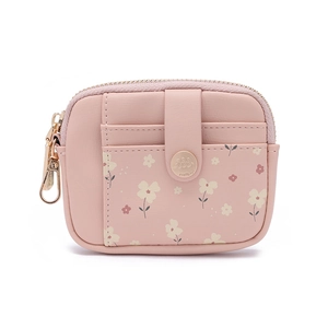 Macro detail of pink floral wallet featuring gold snap button and premium leather texture