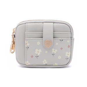 Close-up of small grey faux leather wallet with floral prints and rose gold snap button