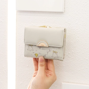 Close-up of PU leather floral short wallet with gold hardware and forest illustration