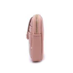 Side view of slim pink bifold wallet featuring white floral prints and gold zipper